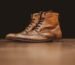 Brown leather boots on wooden surface - leather shoe care guide NZ How to Care for Leather Shoes & Boots NZ