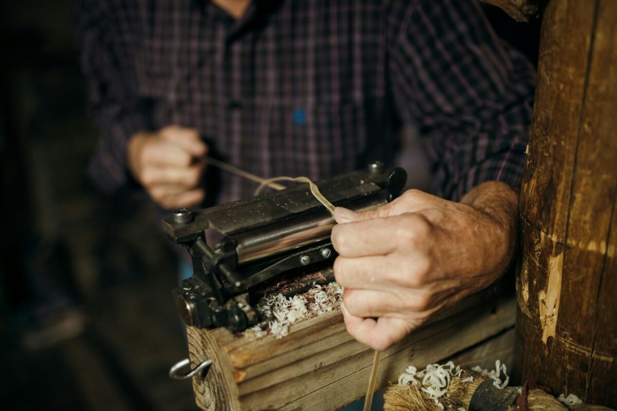 Skilled artisan working on premium leather goods in workshop - Winter Olympics
